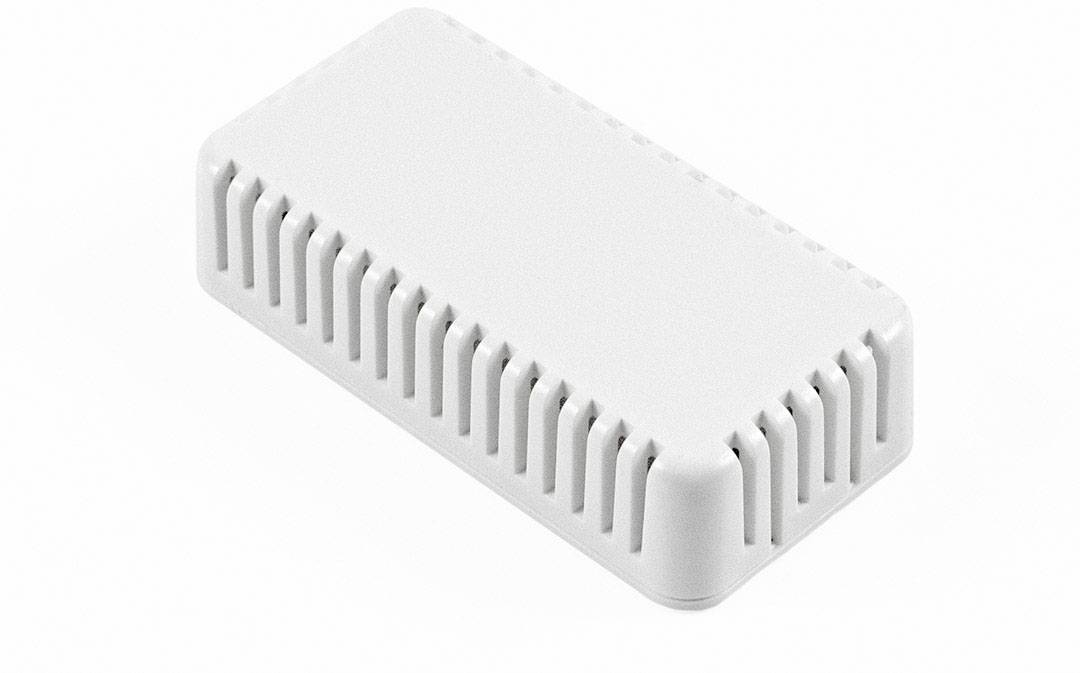 A rectangular, white plastic device with ventilated edges, lying on a white surface.