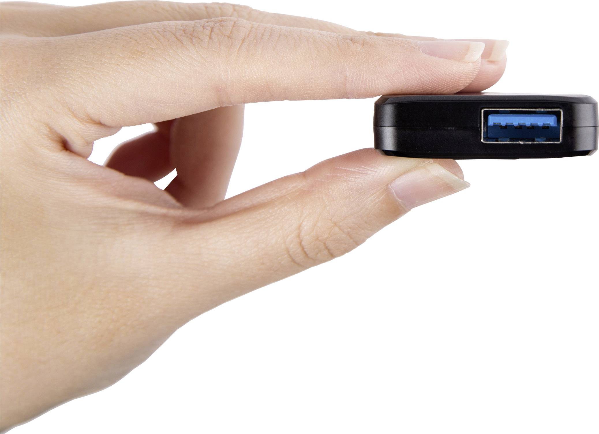 A hand holds a black USB device with a blue USB port, demonstrating the compact size of the device.