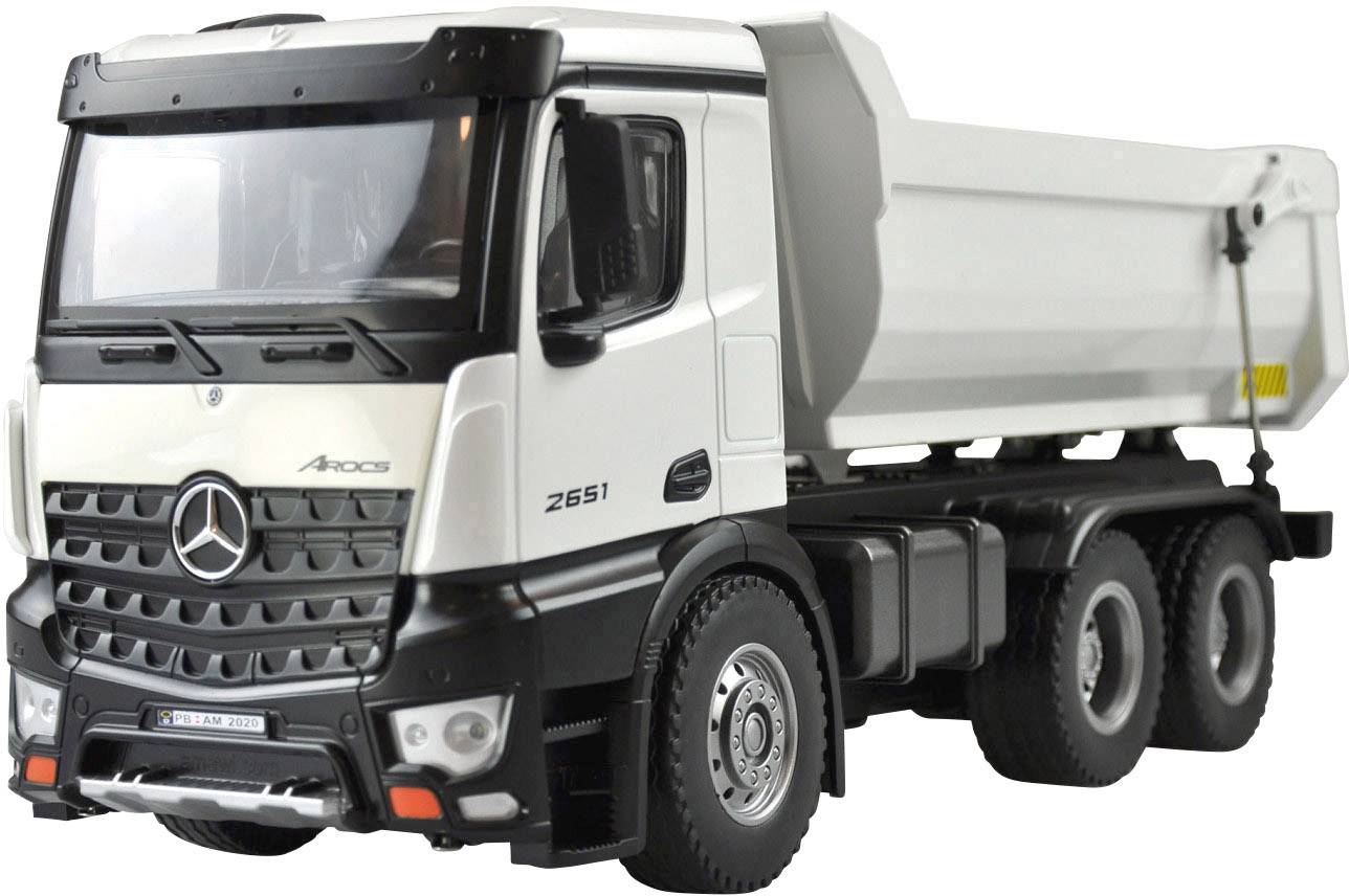 White and black tipper lorry parked on a closed car park.