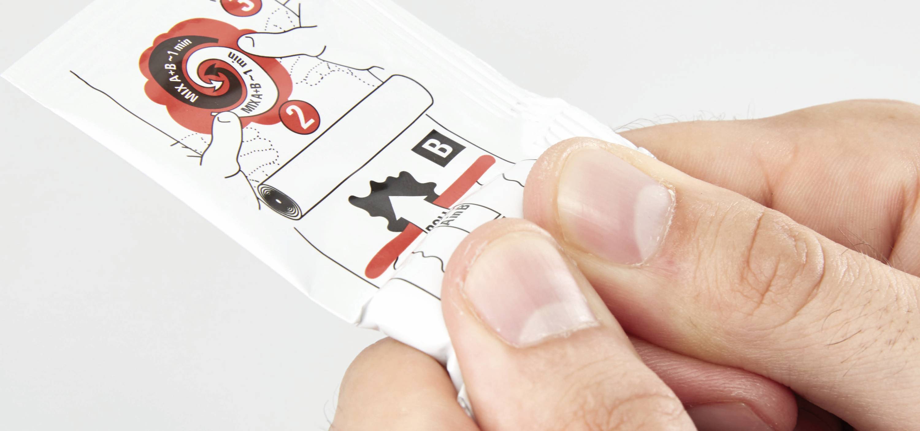 A hand is holding a package with instructions '1' and '2' for opening, along with a black symbol and the letter 'B'.
