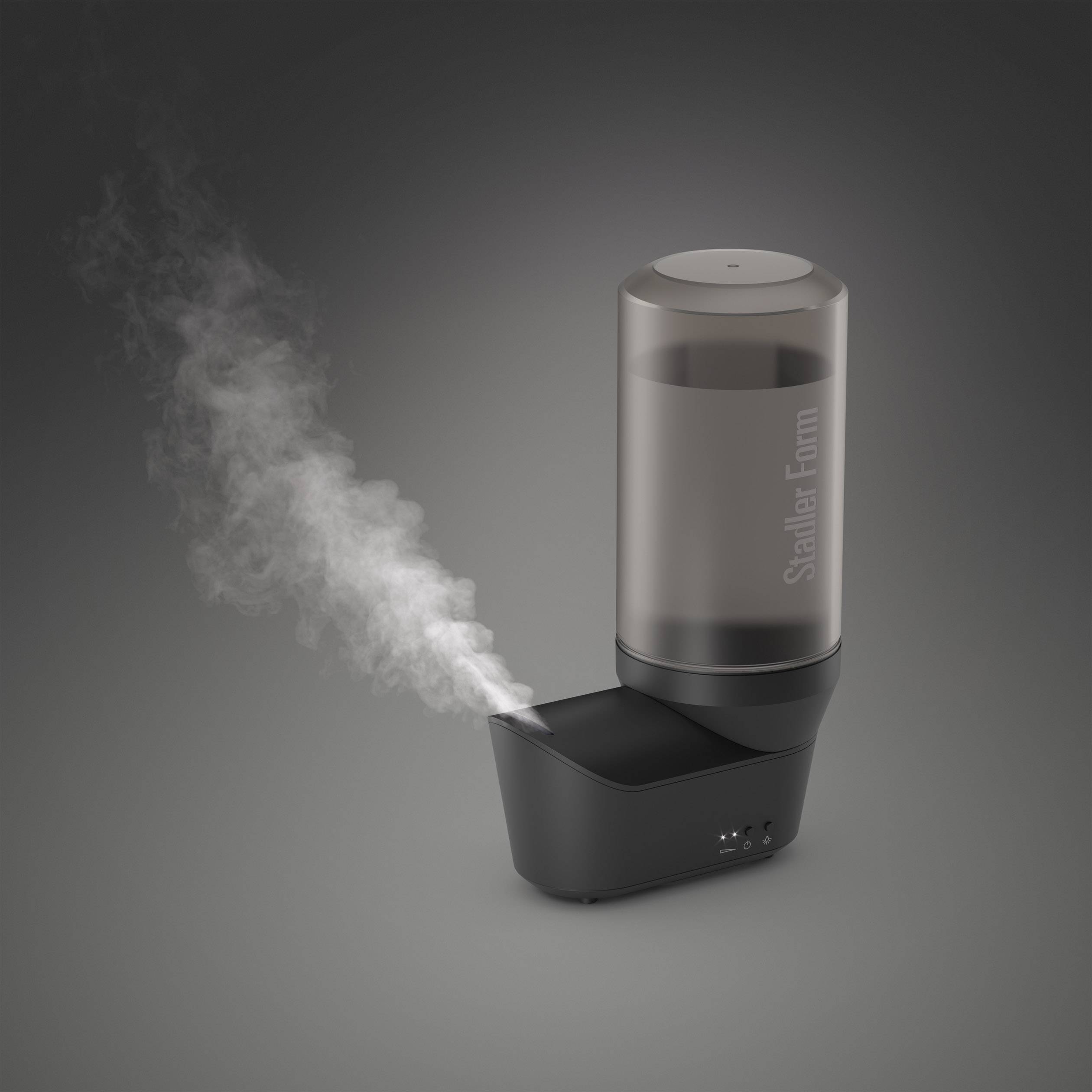 A black humidifier is emitting white steam. The device has a cylindrical water tank and a wide base.