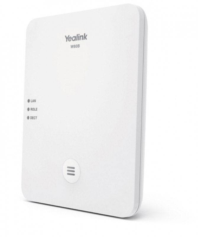 A Yealink W80B DECT base module with LAN, ROLE, and DECT indicator lights. White, minimalist design for wall mounting.