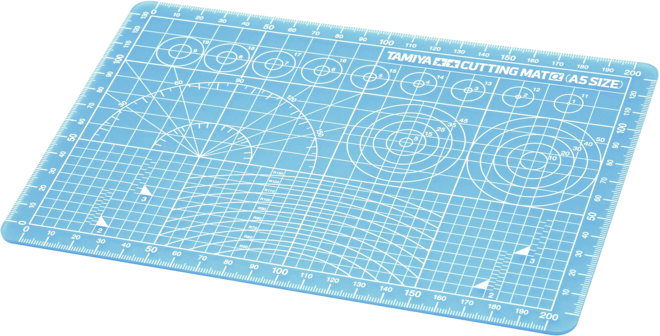A blue cutting mat with a printed grid, circles, and ruler measurements. Used for precise cutting and crafting.Note: While the translation is essentially the same, I used more natural British English phrasing and spelling.