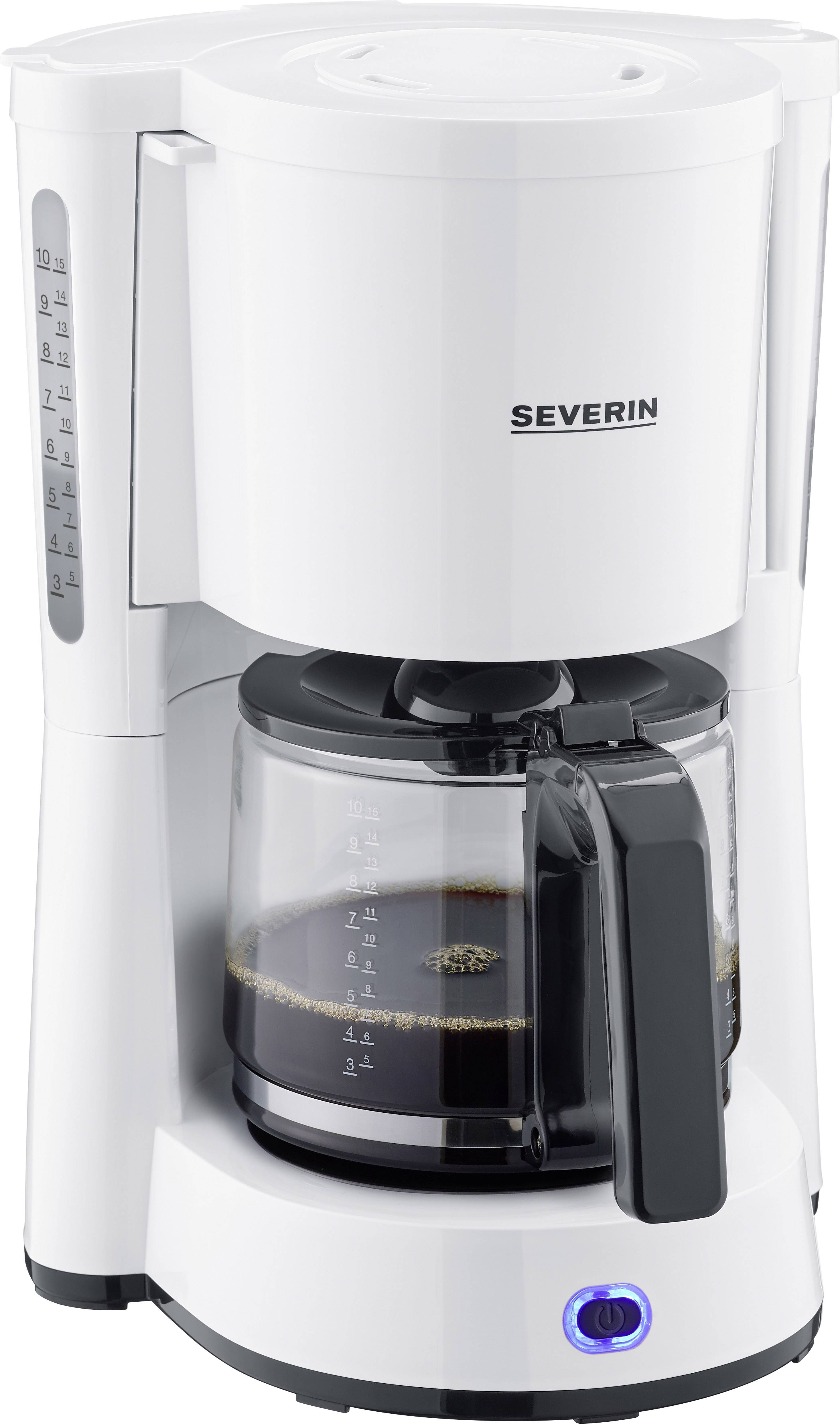 A white filter coffee machine with a glass carafe and water level indicator on the side. The carafe is half-filled with coffee.