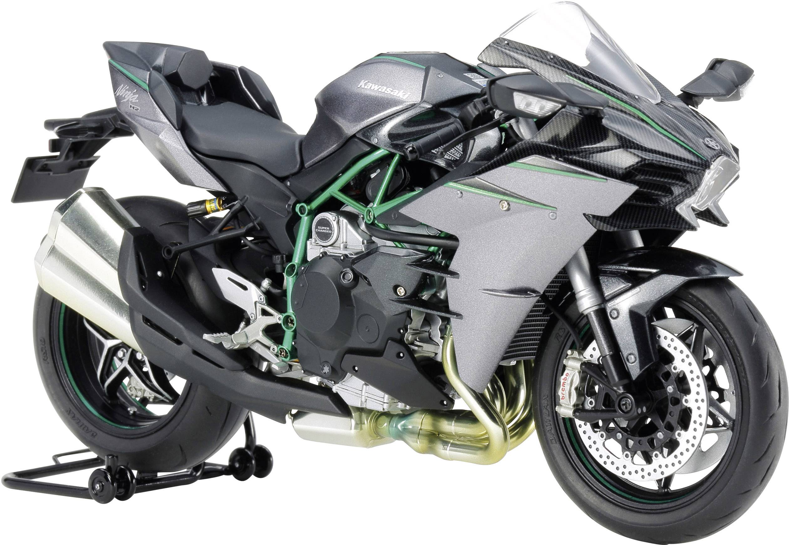 A sporty motorcycle in green and black with aerodynamic fairings, displayed on a stand.