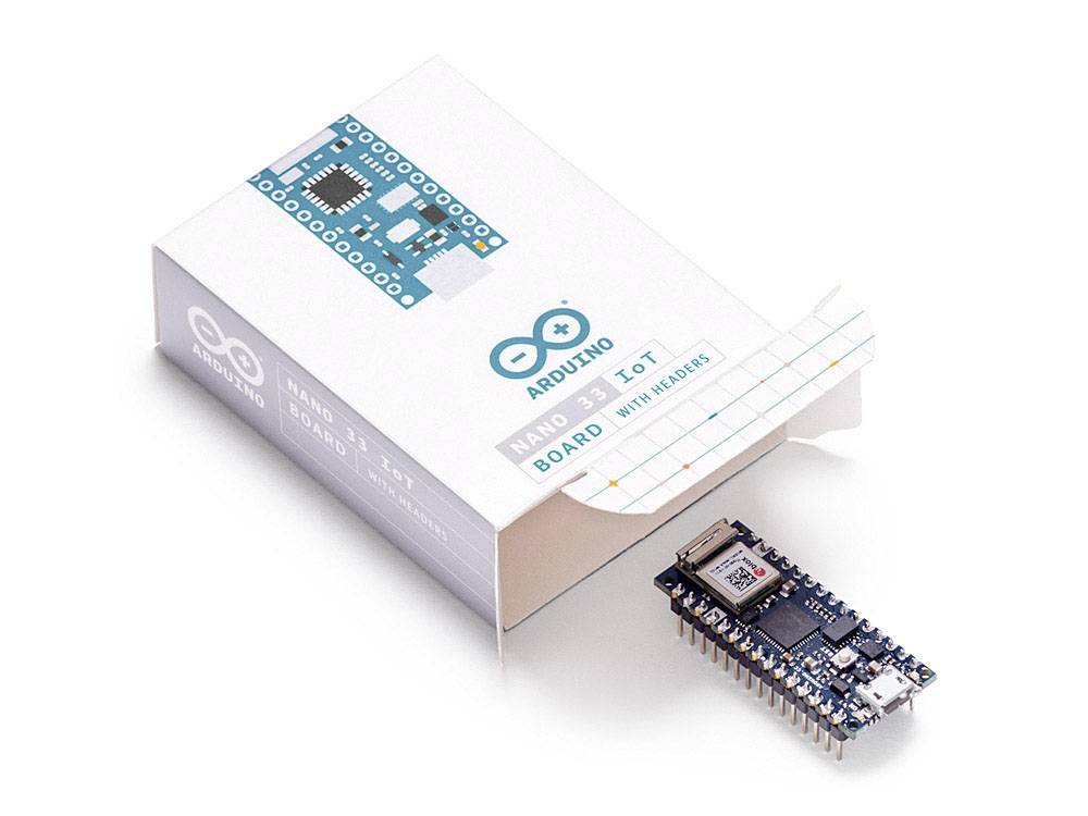Arduino Nano 33 IoT board next to an open package, showcasing its compact design for IoT applications.