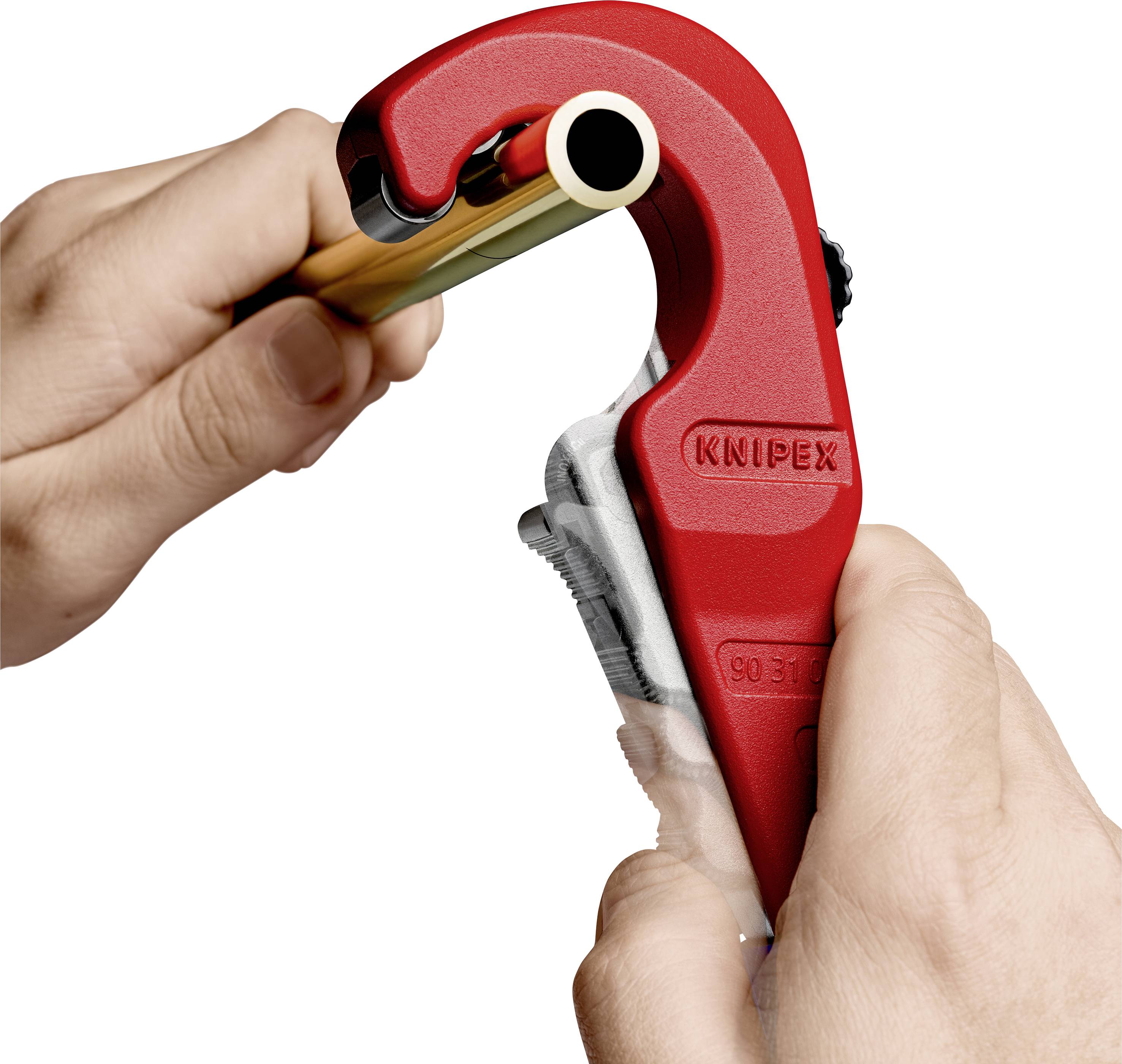 A hand is using a red pipe cutter to cut through a copper pipe. The pipe cutter is positioned on the pipe.