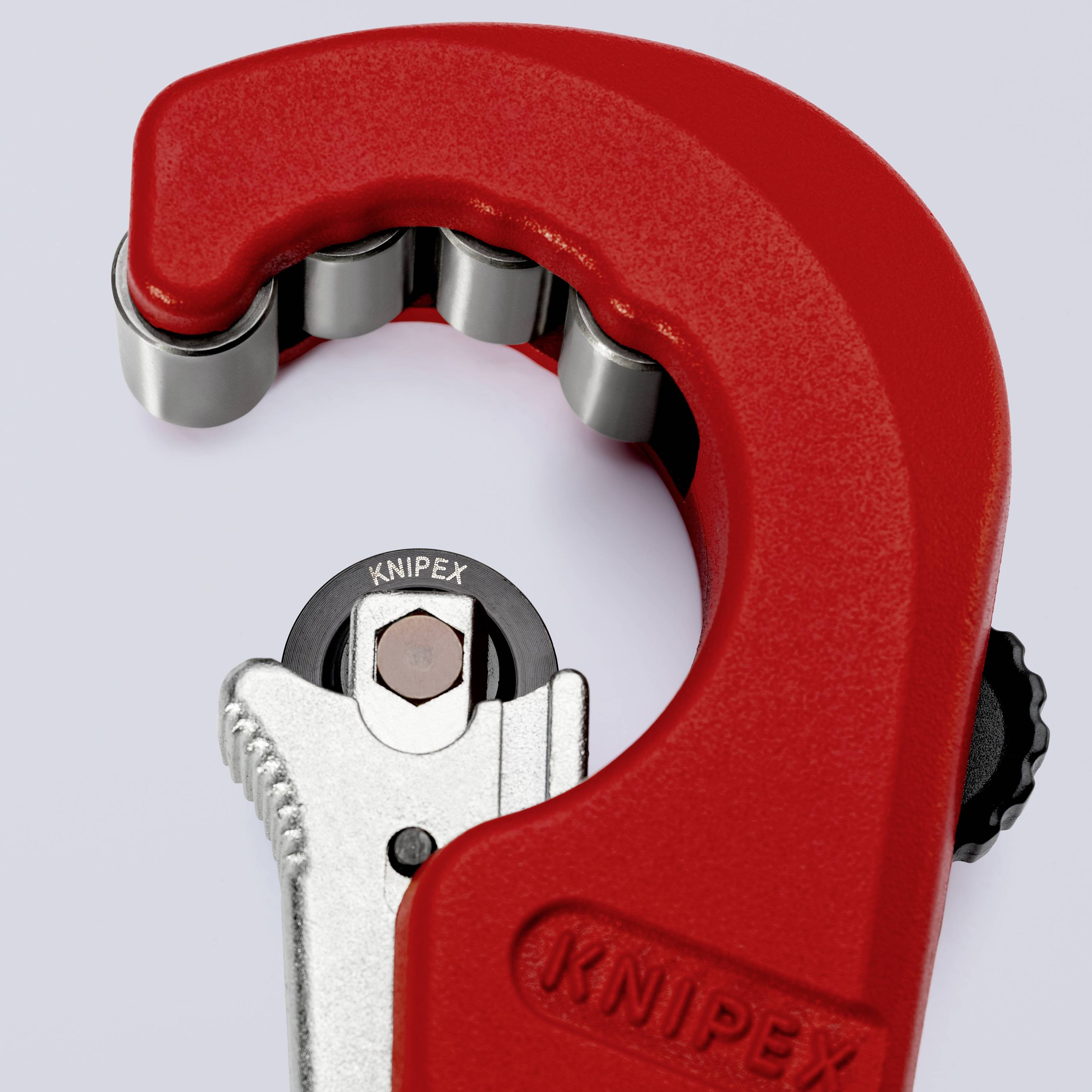 Pipe Cutter in Close-up: Red and black with silver cutting area, brand name visible, designed for precise metal pipe cutting.