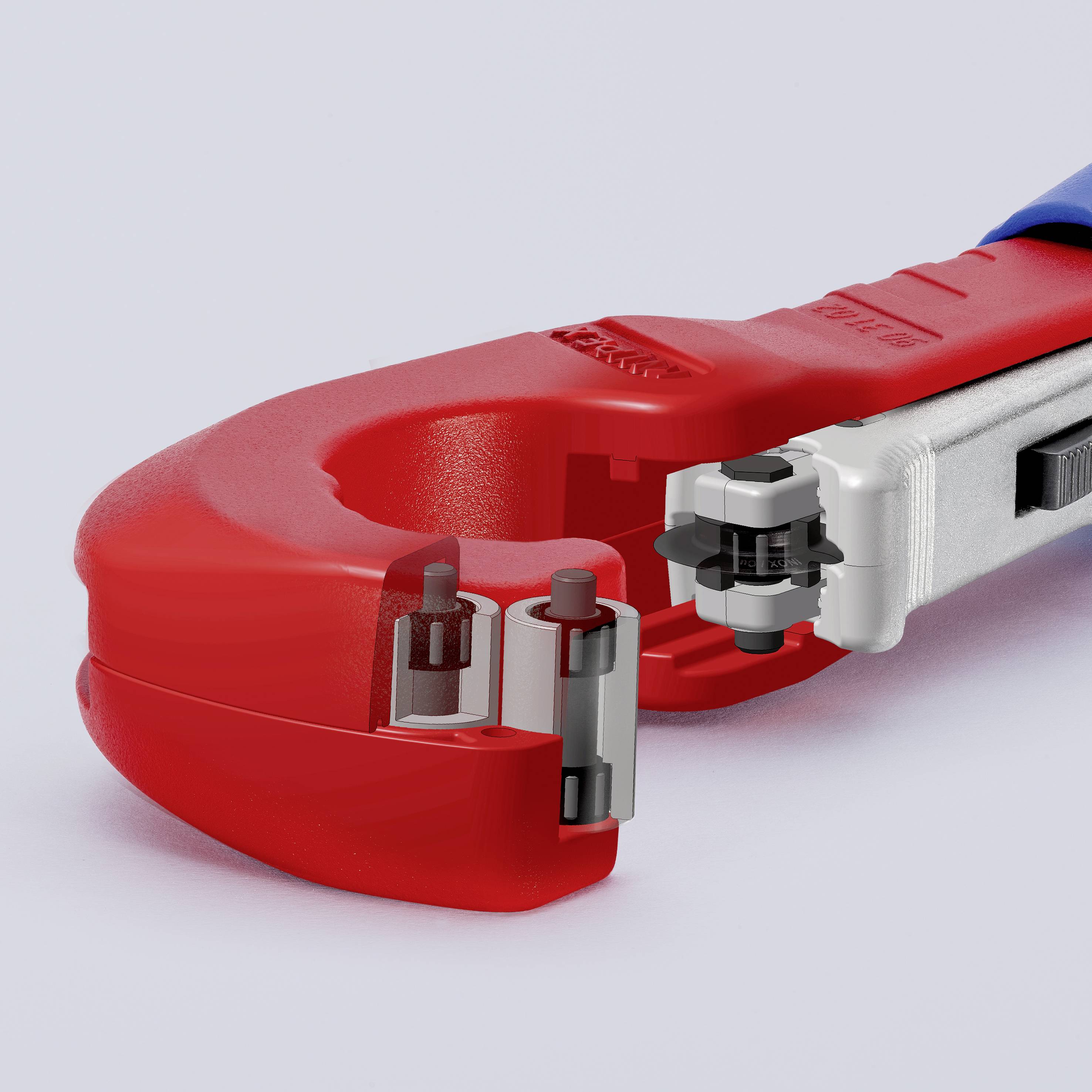 A red pipe cutting machine with a silver handle and blade, cutting a section of pipe.