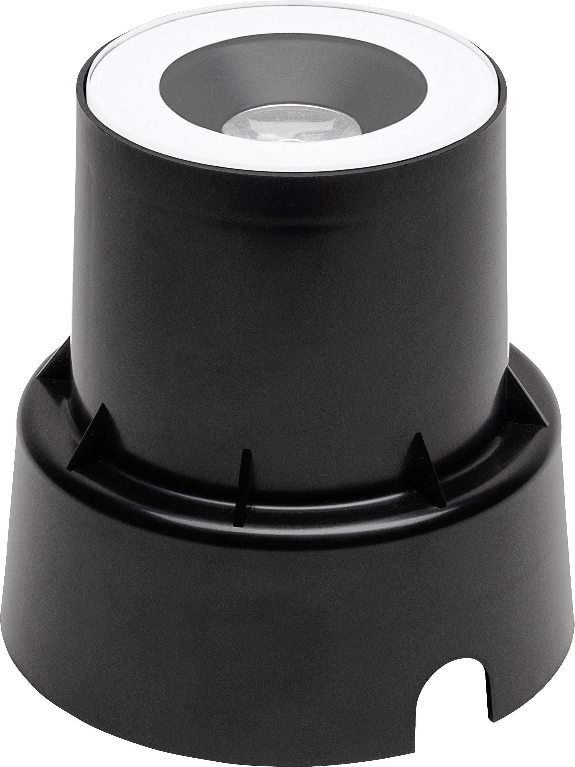 A black, cylindrical object with a wide base and recessed top surface. Likely a recessed ground spotlight.