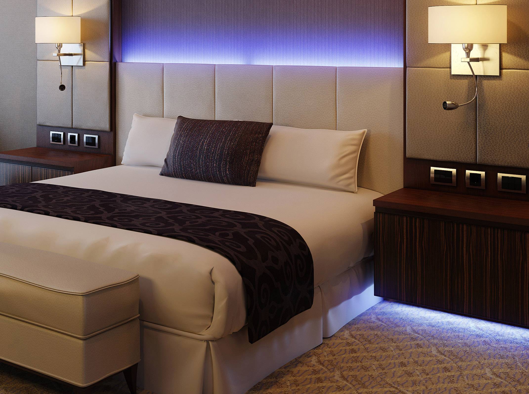 A modern hotel room with a large double bed, soft pillows, and stylish lighting.