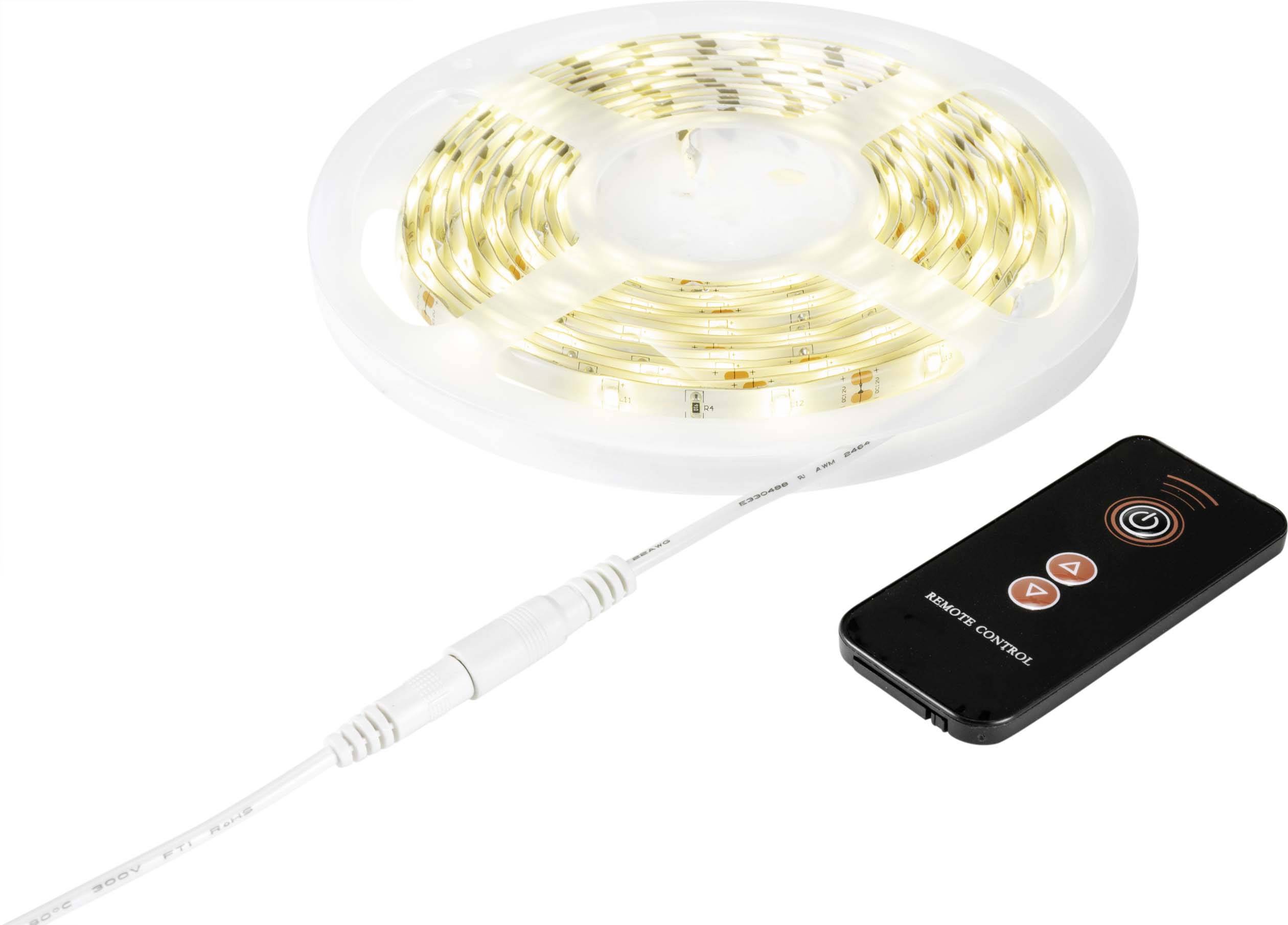 A coiled LED light string beside a black remote control with red buttons.