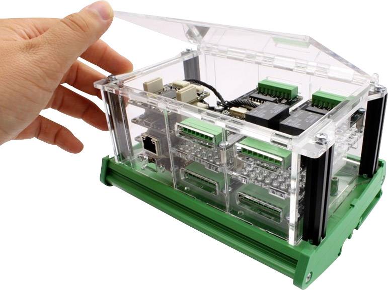 A hand lifts the transparent lid of an electrical control box filled with circuits and connections.
