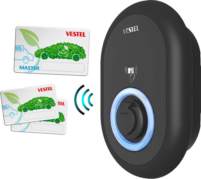 A black charging station by Vestel with an illuminated blue circle. Two RFID cards beside it: 'Master' and 'Vestel', each with a green automotive design.