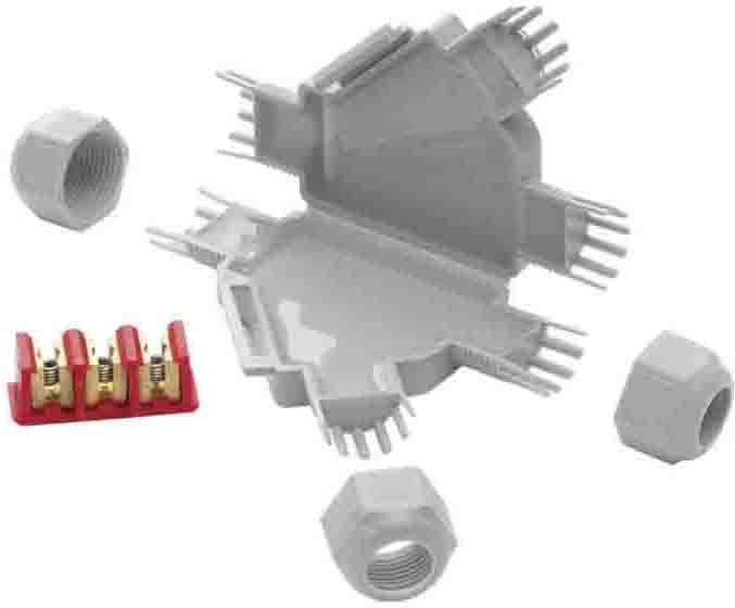 Plastic enclosure in the shape of an eagle with plug contacts and red terminals, surrounded by three screw caps.