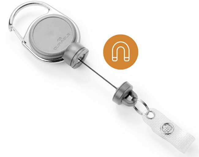 A silver key fob with an extendable steel cable. An orange label displays a magnet symbol.