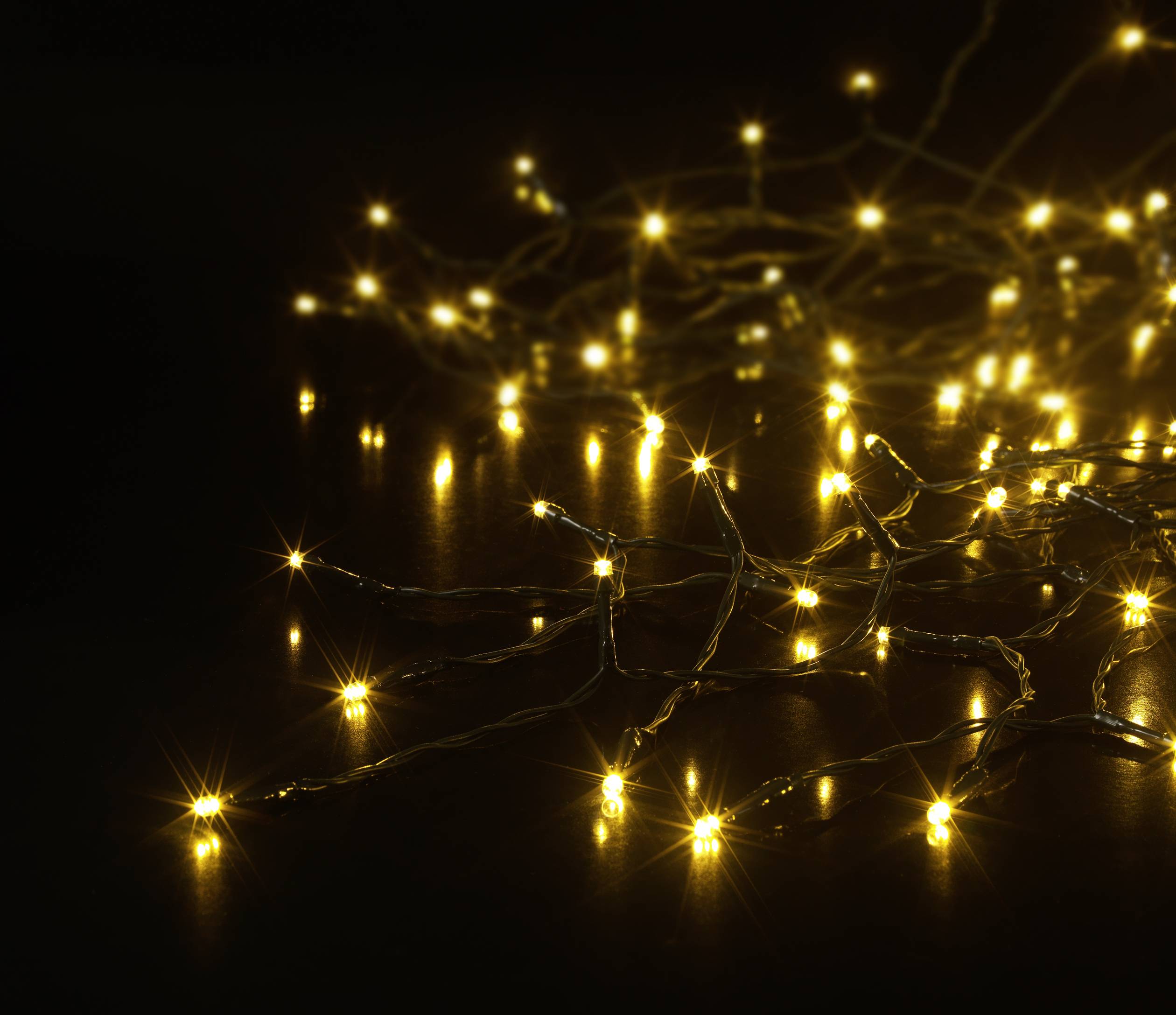 String of fairy lights with warm white LED bulbs that illuminate in a dark environment, creating a cosy atmosphere.