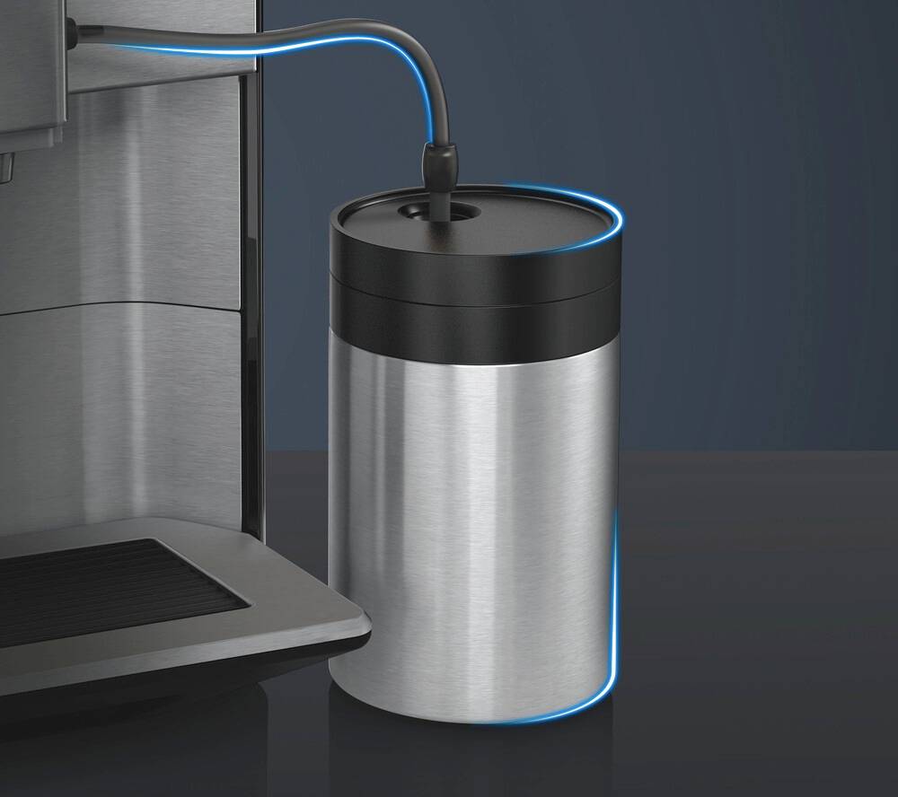 A coffee machine with an external silver milk container, connected by a blue tube.