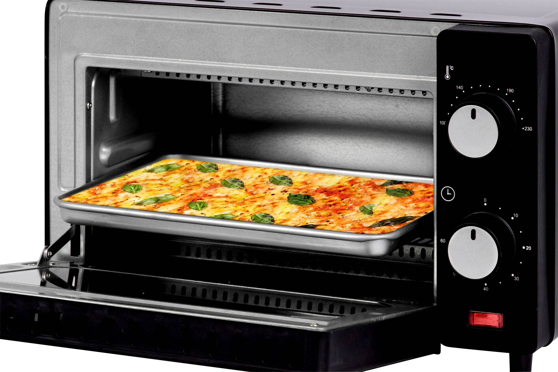 An oven with its door open shows a rectangular pizza with cheese and basil on a baking tray inside.