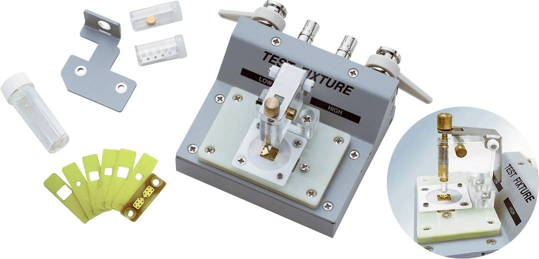 Test device with accessories for electronic component testing. Contains sample holders, test strips, and connection mechanisms.