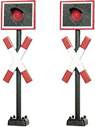 Two red railway signal lights with black housings and red cross signs. They are positioned side by side and are displaying stop signals.