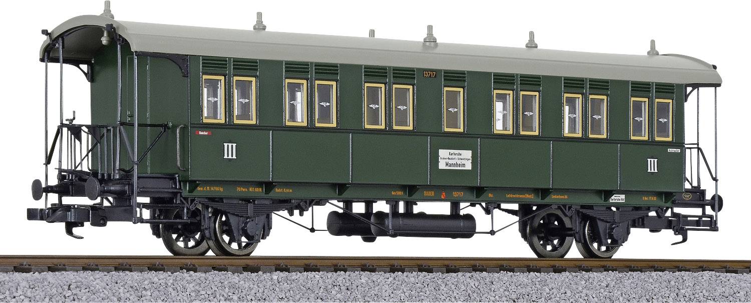 Green historical railway carriage with yellow window frames standing on train tracks. Labelled with 'III', indicating the carriage class.