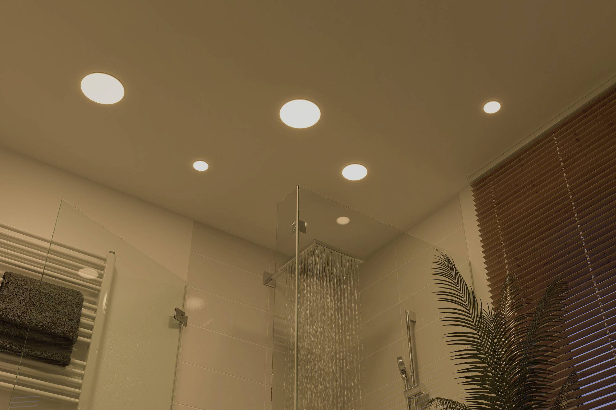 Ceiling lighting in a modern bathroom with multiple recessed lights, a large shower enclosure, and plants on the window sill.