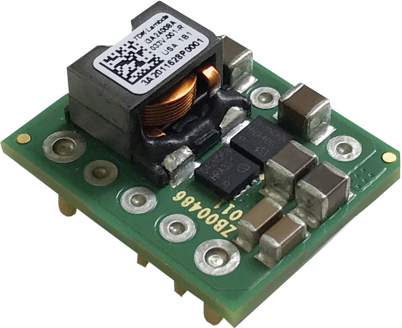 A green, square electronic circuit board with a large black transformer and several capacitors and resistors mounted on it.