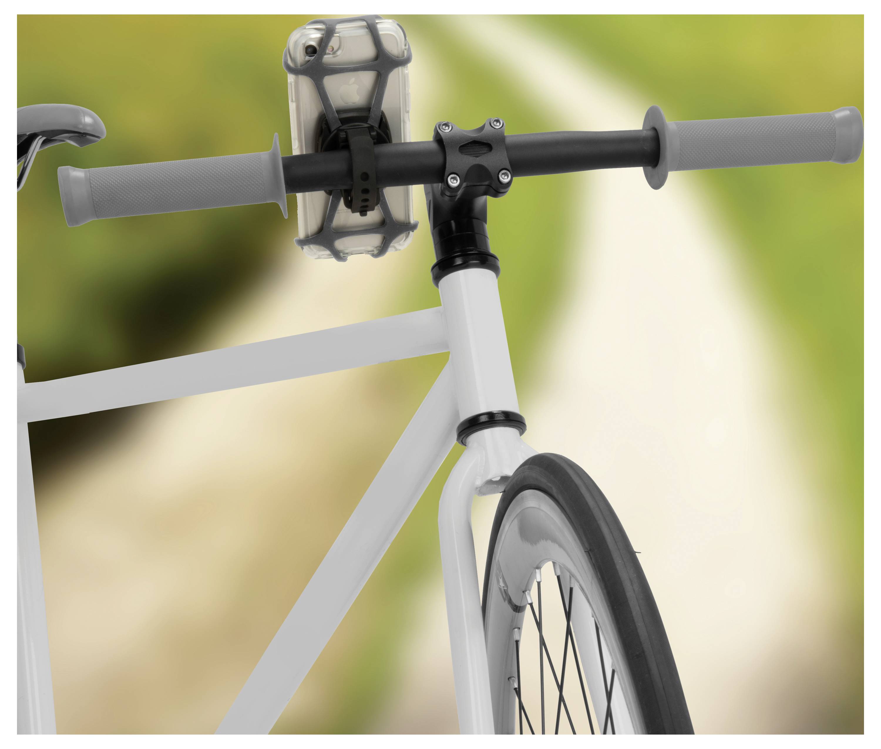 A bicycle handlebar with a mounted smartphone holder is shown against a blurred nature background, suggesting a cycling route.