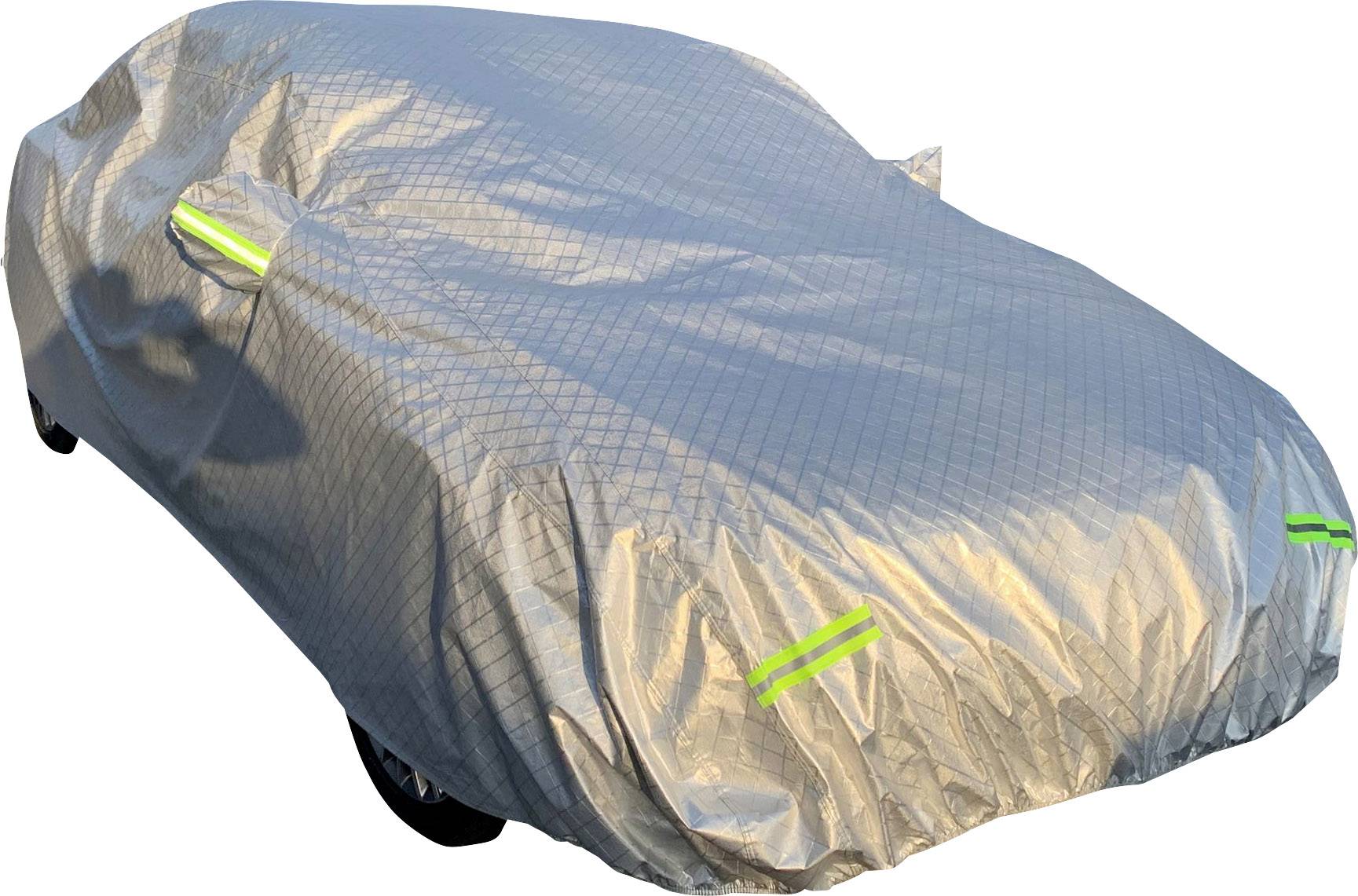 A car is parked under a silver cover. The cover has reflective stripes on the sides and front.