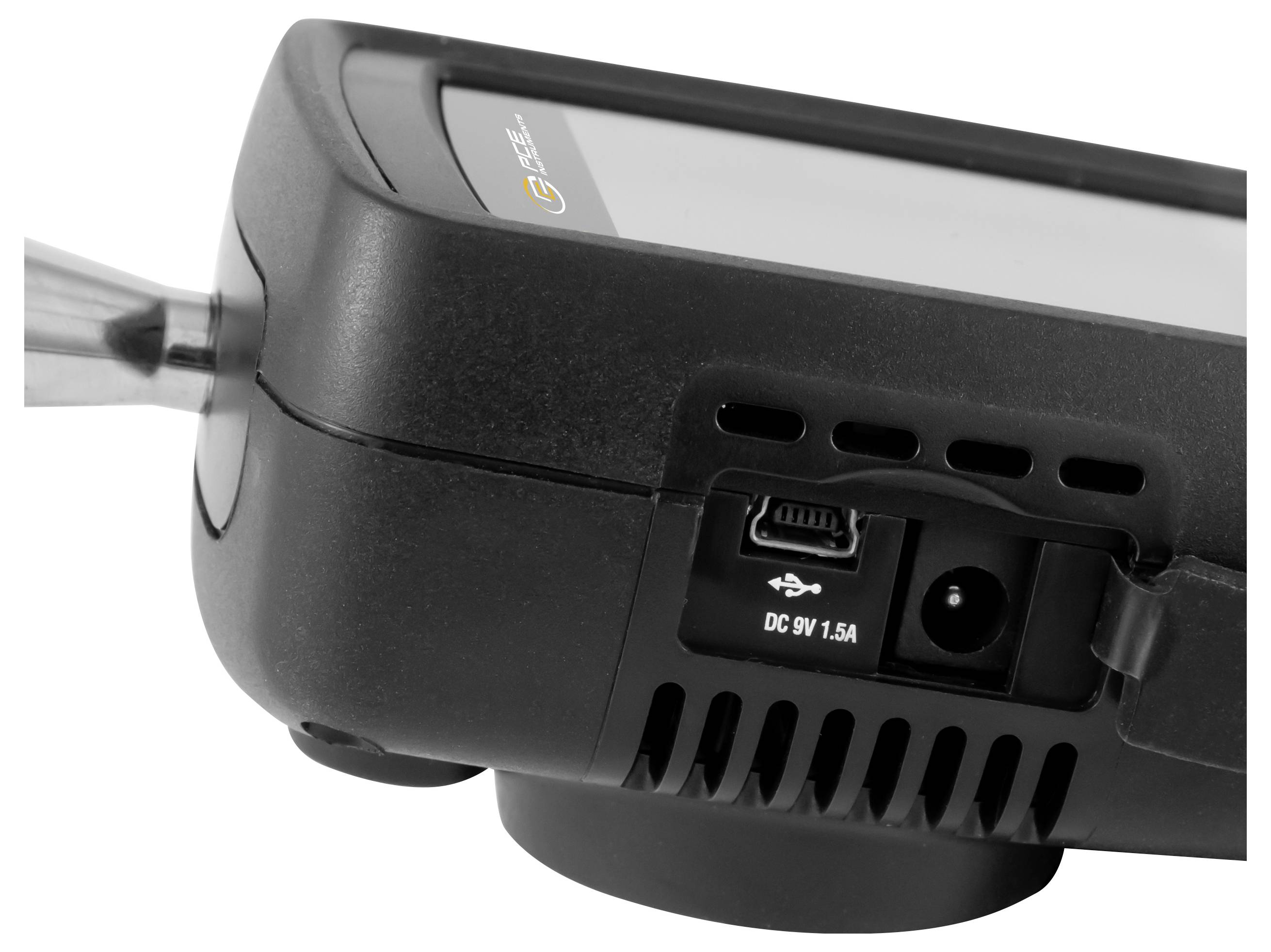 Close-up of a portable projector's rear panel showing USB port and DC 9V power input, with cable plugged in.