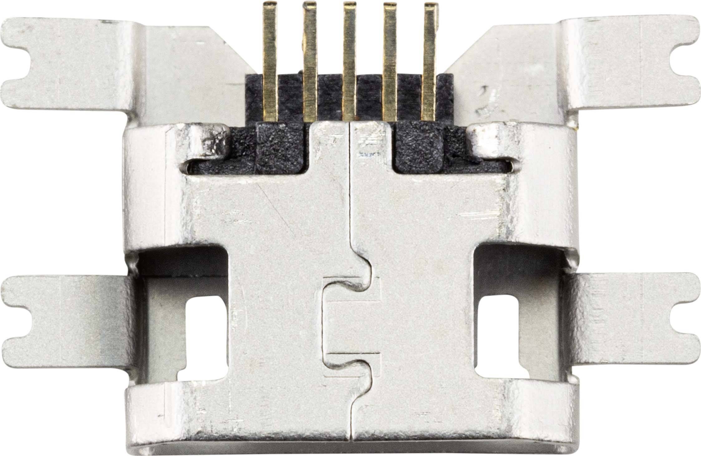 Metal clip with five protruding plug contacts, emerging from a black plastic housing. Clip has side mounting tabs.