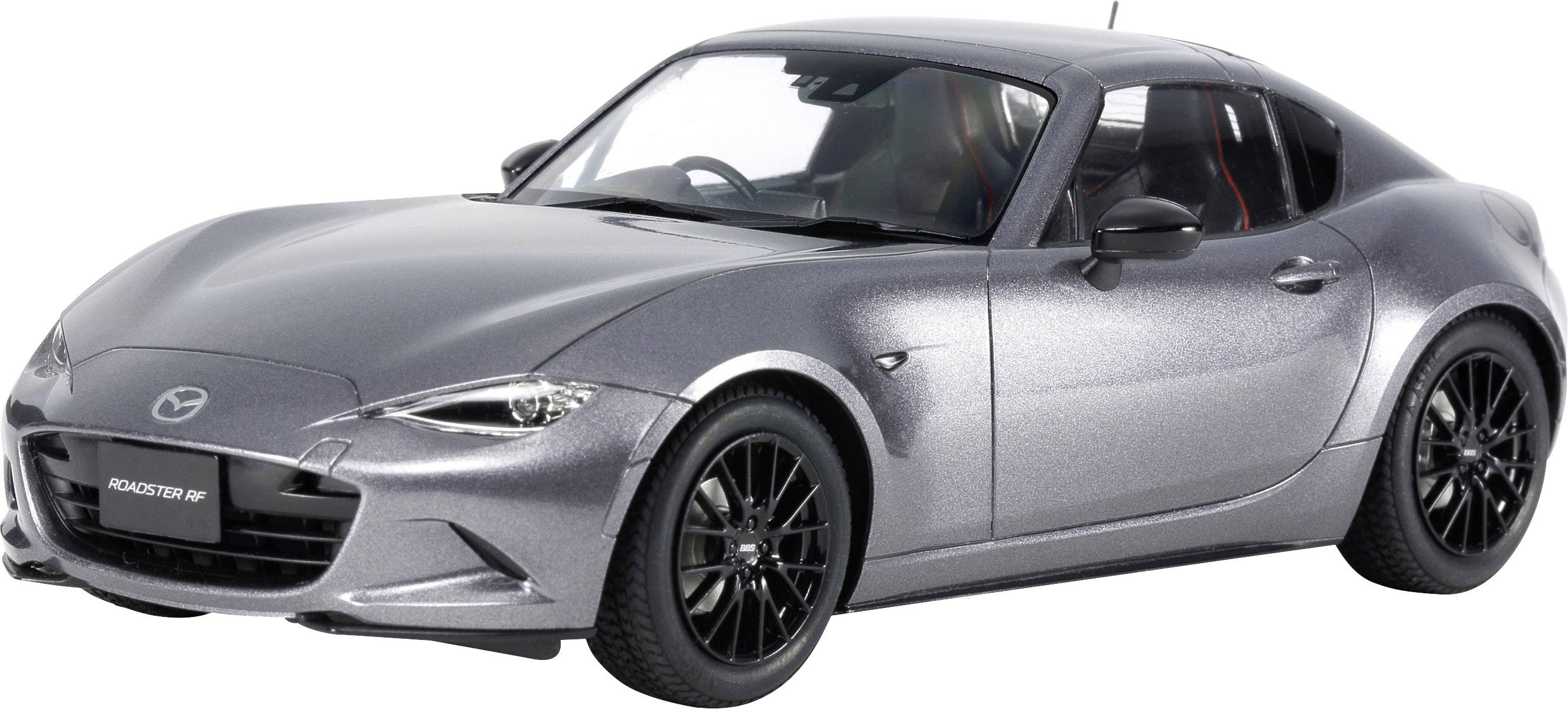 A silver sports coupé on a grey background, focused on the left side of the vehicle; shows modern design and aerodynamics.