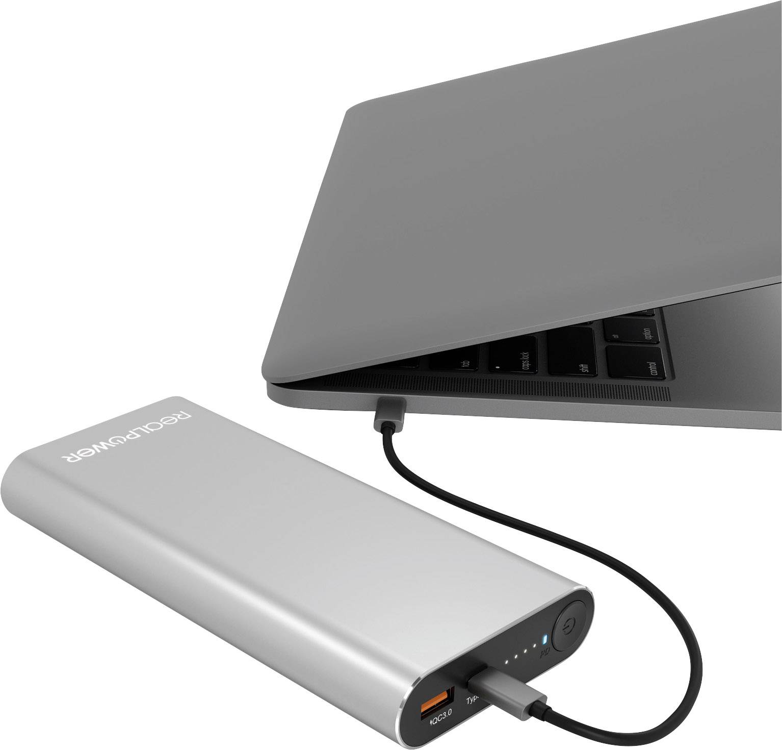 A laptop is being powered via a USB cable from a silver power bank.