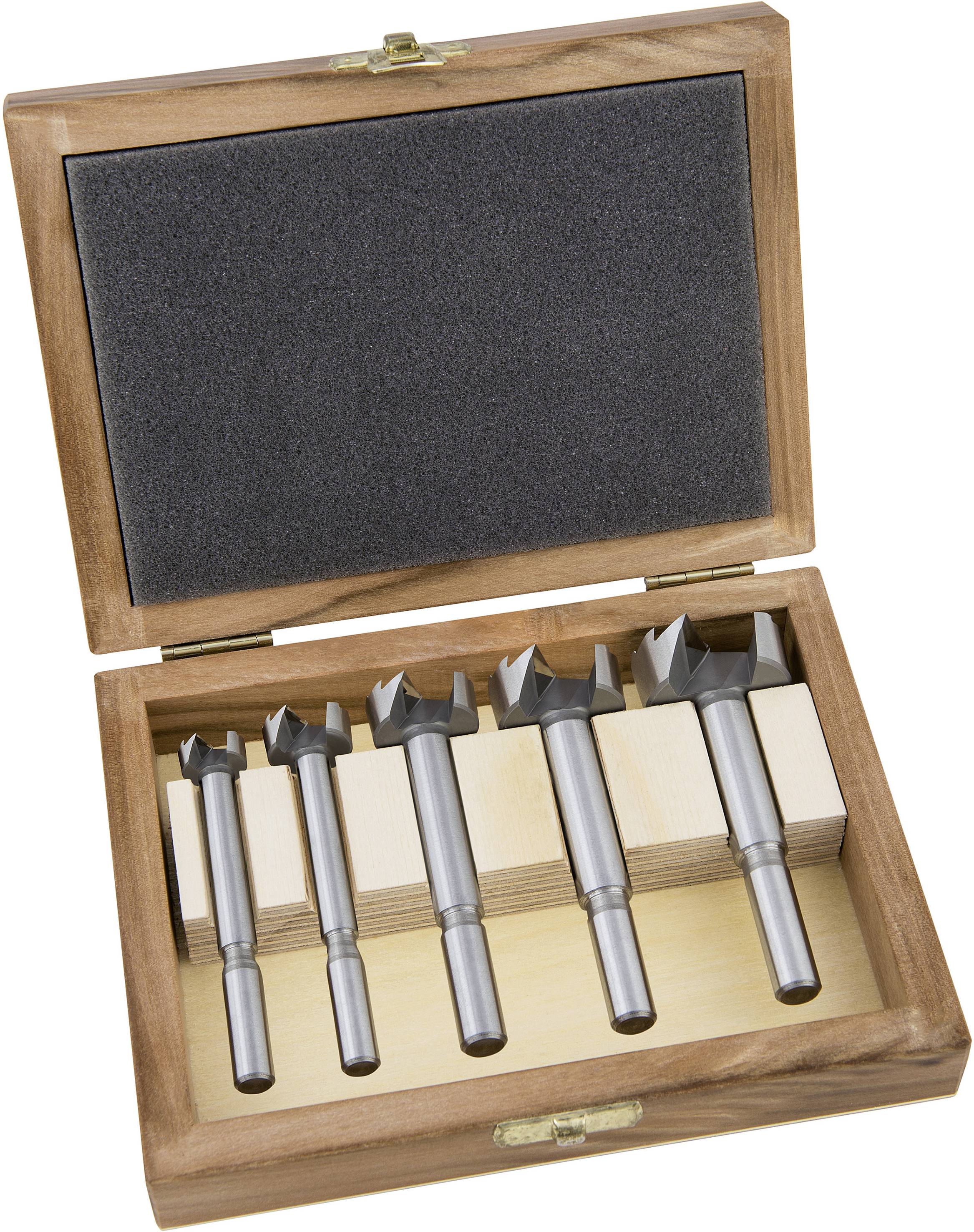A set of Forstner drill bits in an open wooden box with five bits of different sizes. Ideal for precise woodworking.