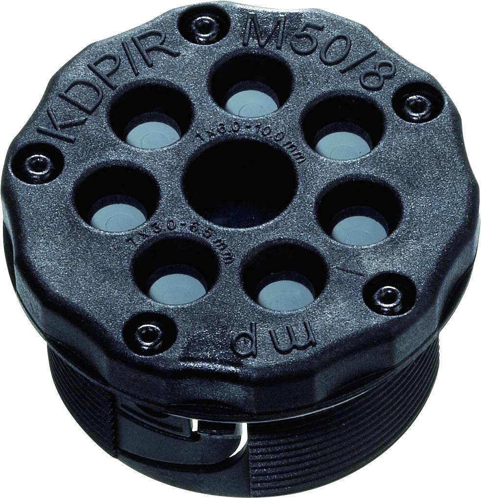 Round, black plastic cover with multiple holes designed for cable routing. Top surface marked with technical annotations.