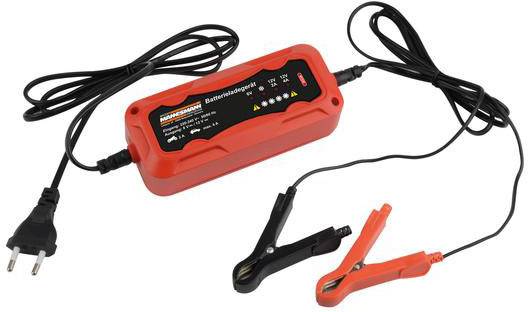 A red battery charger with an LCD display, two cables and crocodile clips for connecting to car batteries.