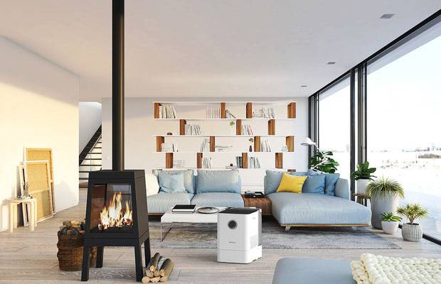 Spacious living room with large windows, a modern fireplace, air purifier and blue sofa. Bright, welcoming atmosphere.