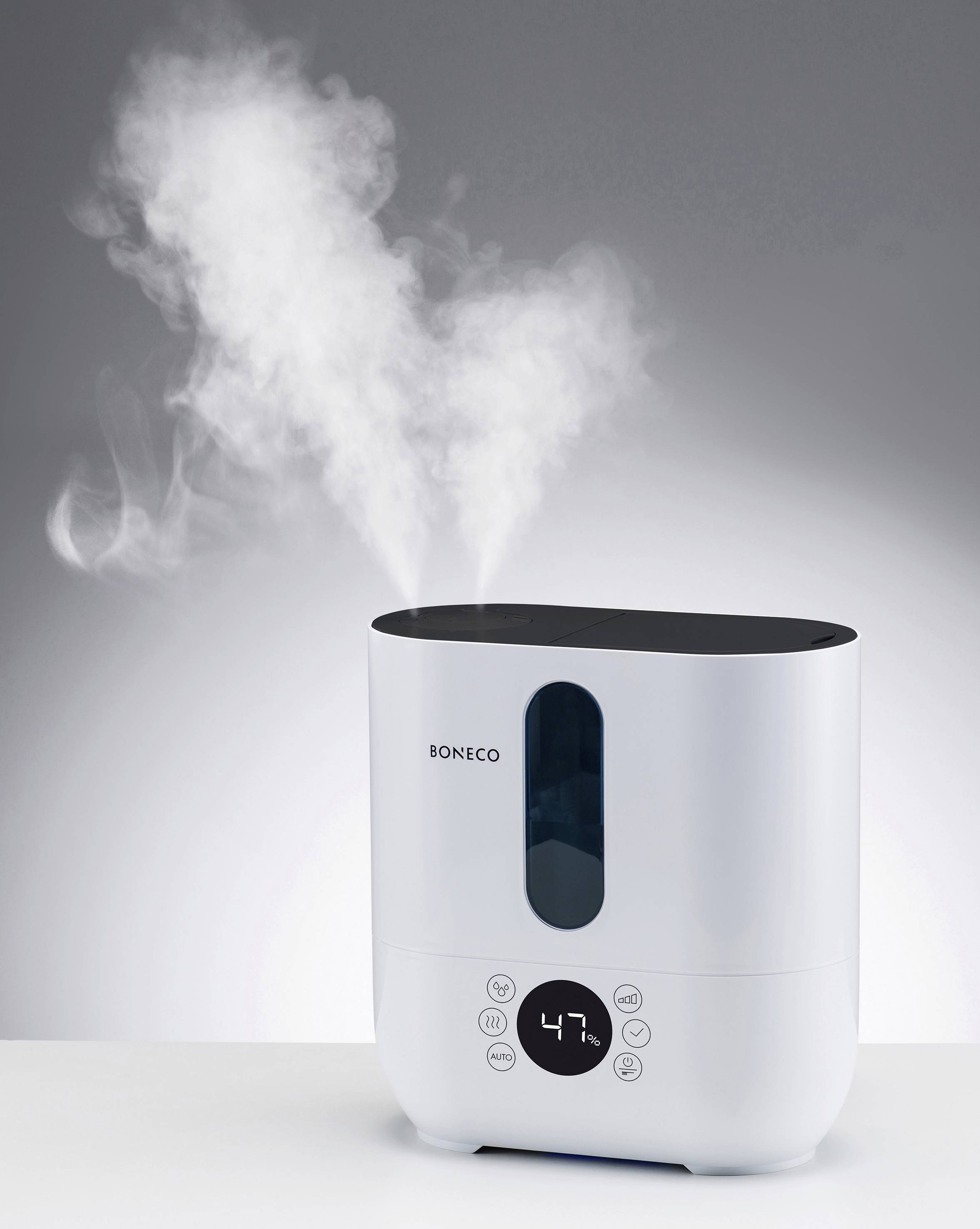 Humidifier with digital display showing '47%', steaming, against a light background.