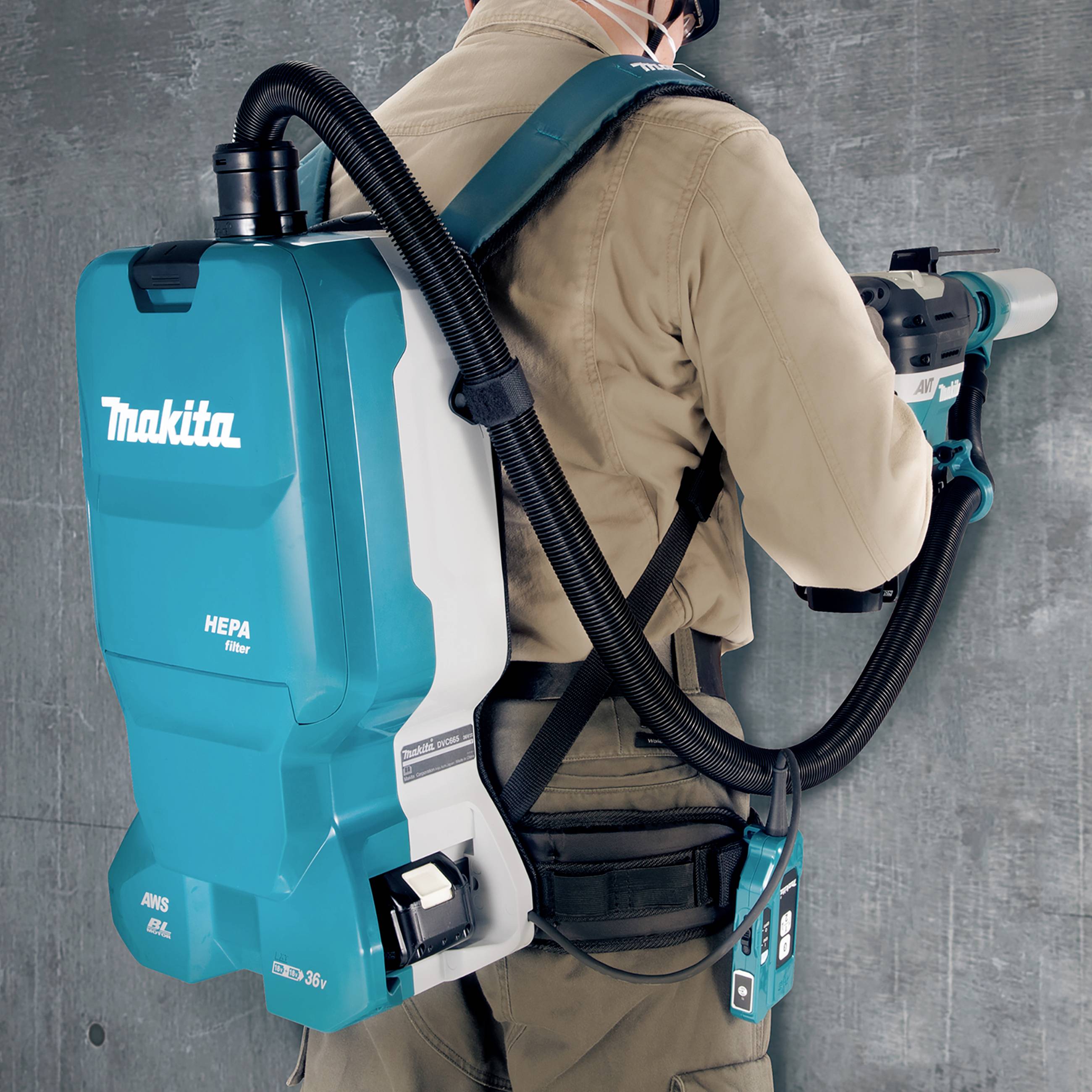 A person with a backpack vacuum cleaner is cleaning an area. The vacuum cleaner is a Makita brand and has a HEPA filter.