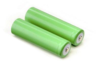 Two green batteries lying side by side on a white background.