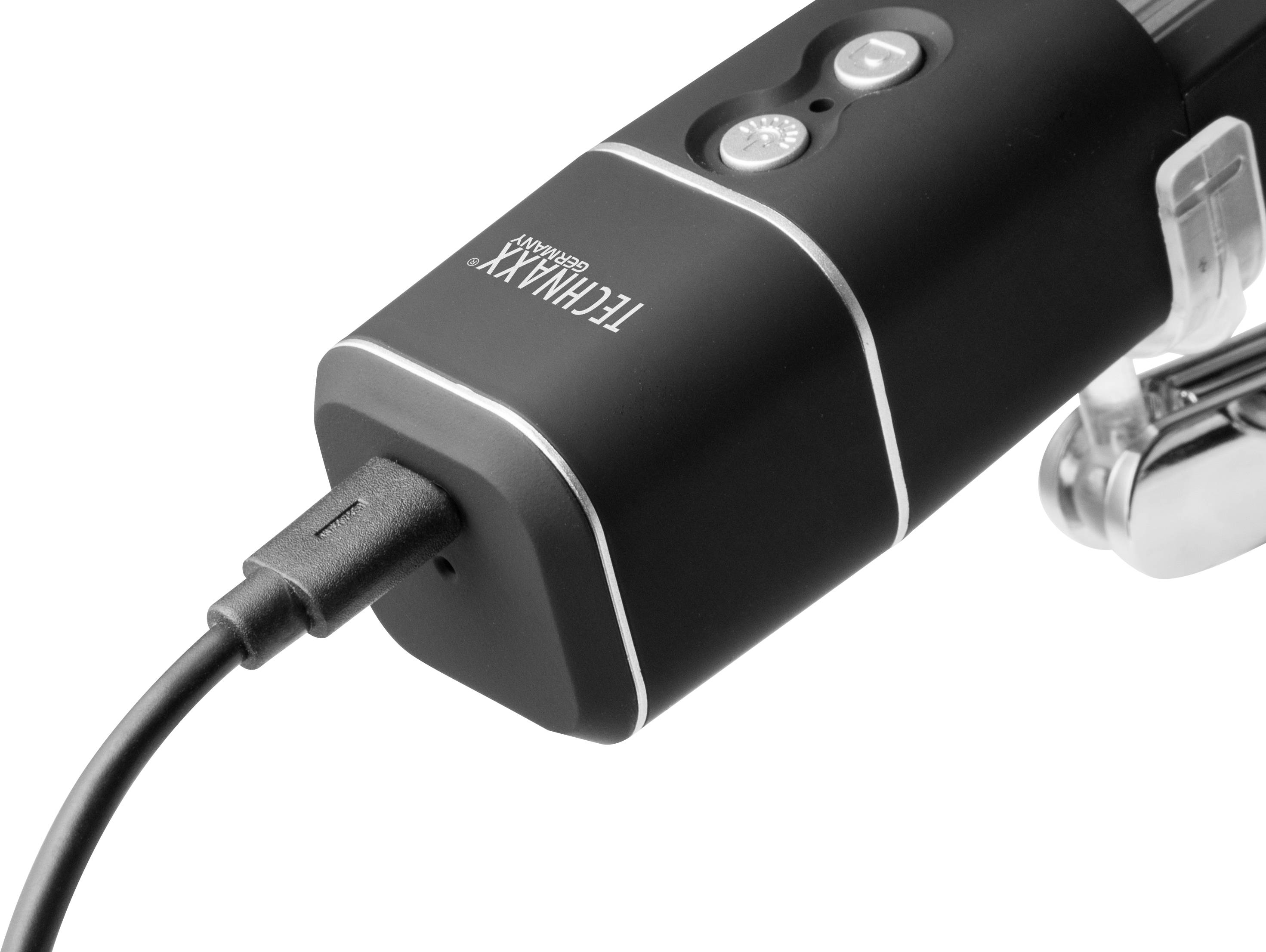 A black technical device with a USB cable connection. Two buttons and an LED light are located on the top.