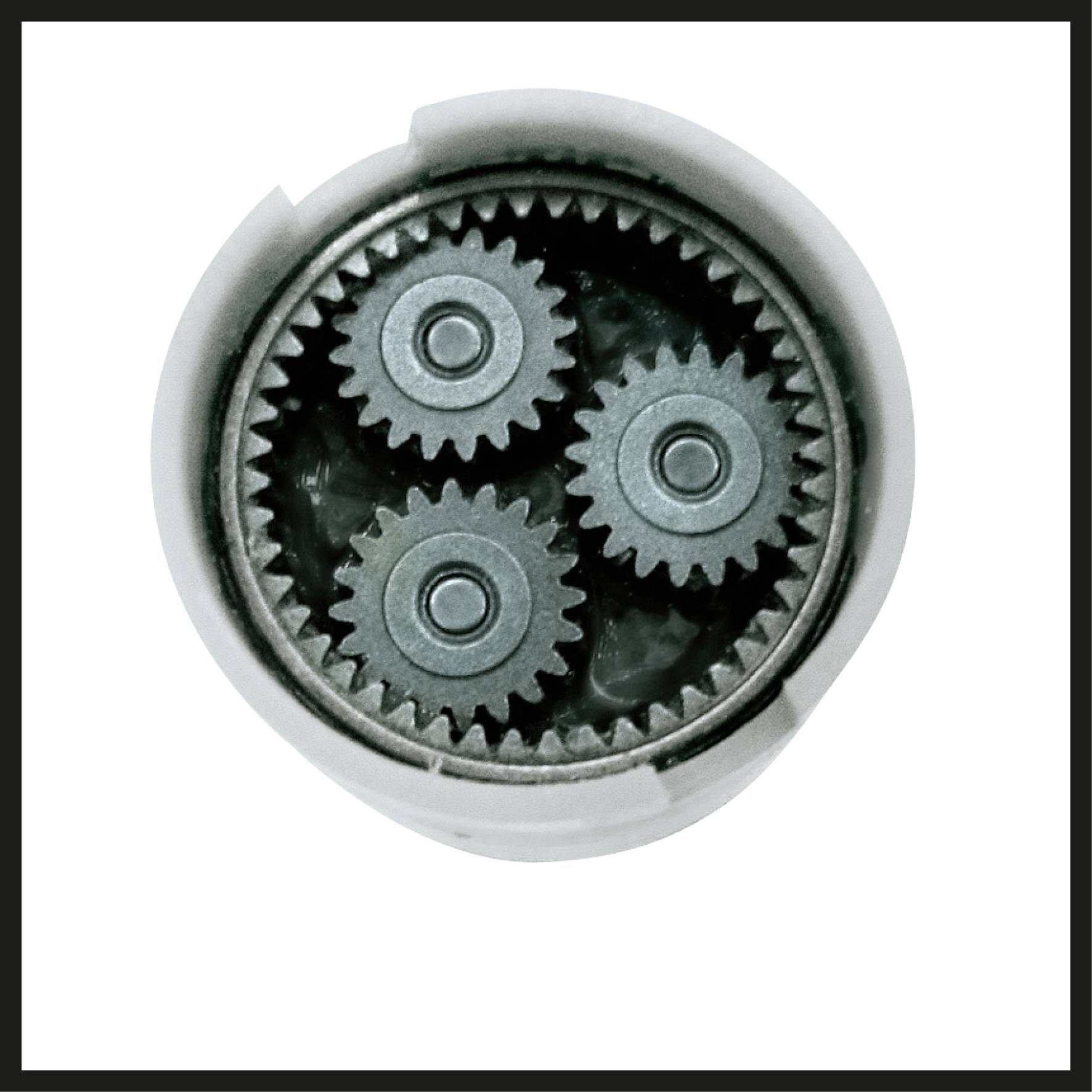 Four interlocking gears in a circular housing, partially obscured.