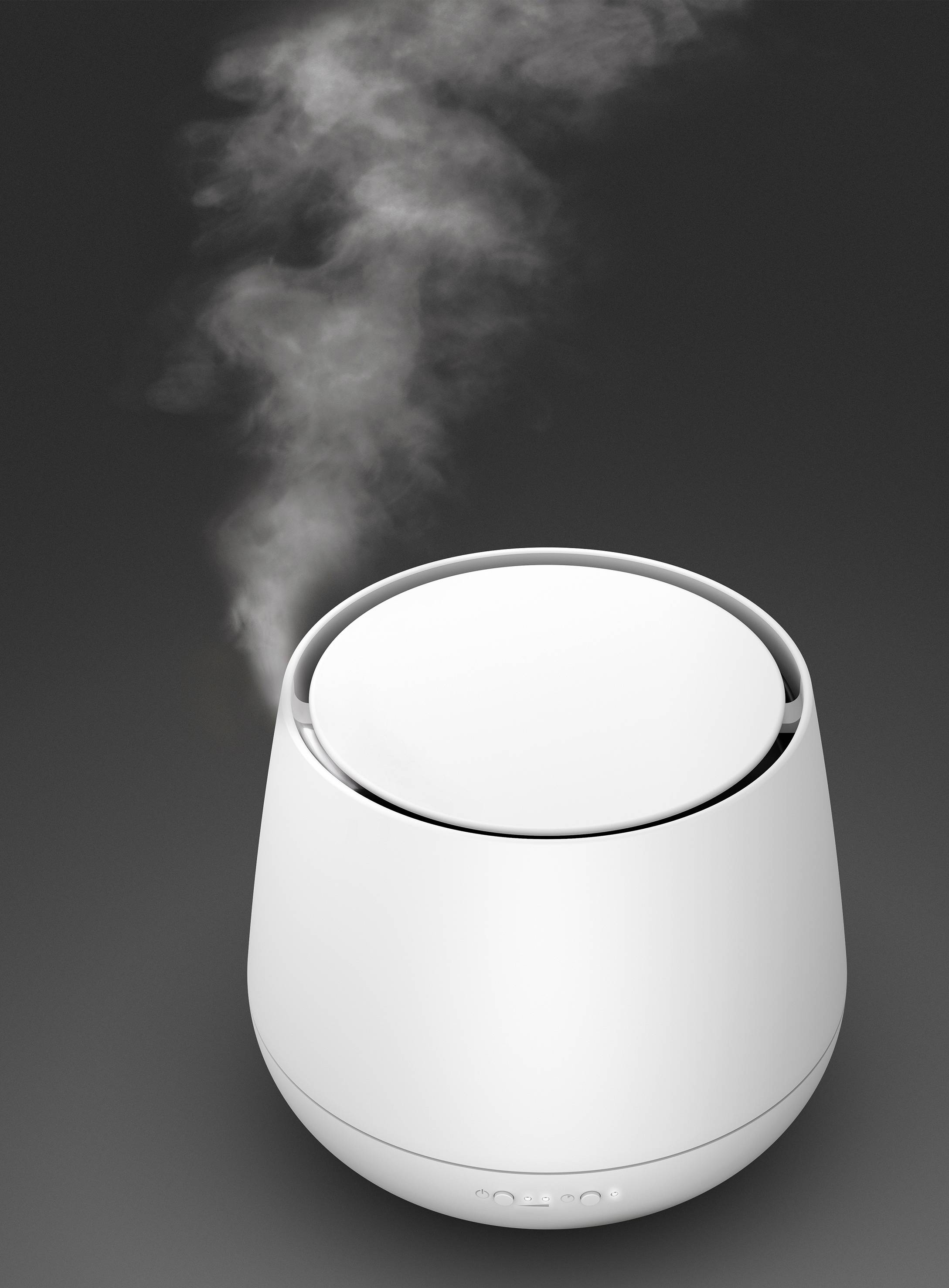 A white air humidifier on a grey background emits fine mist.