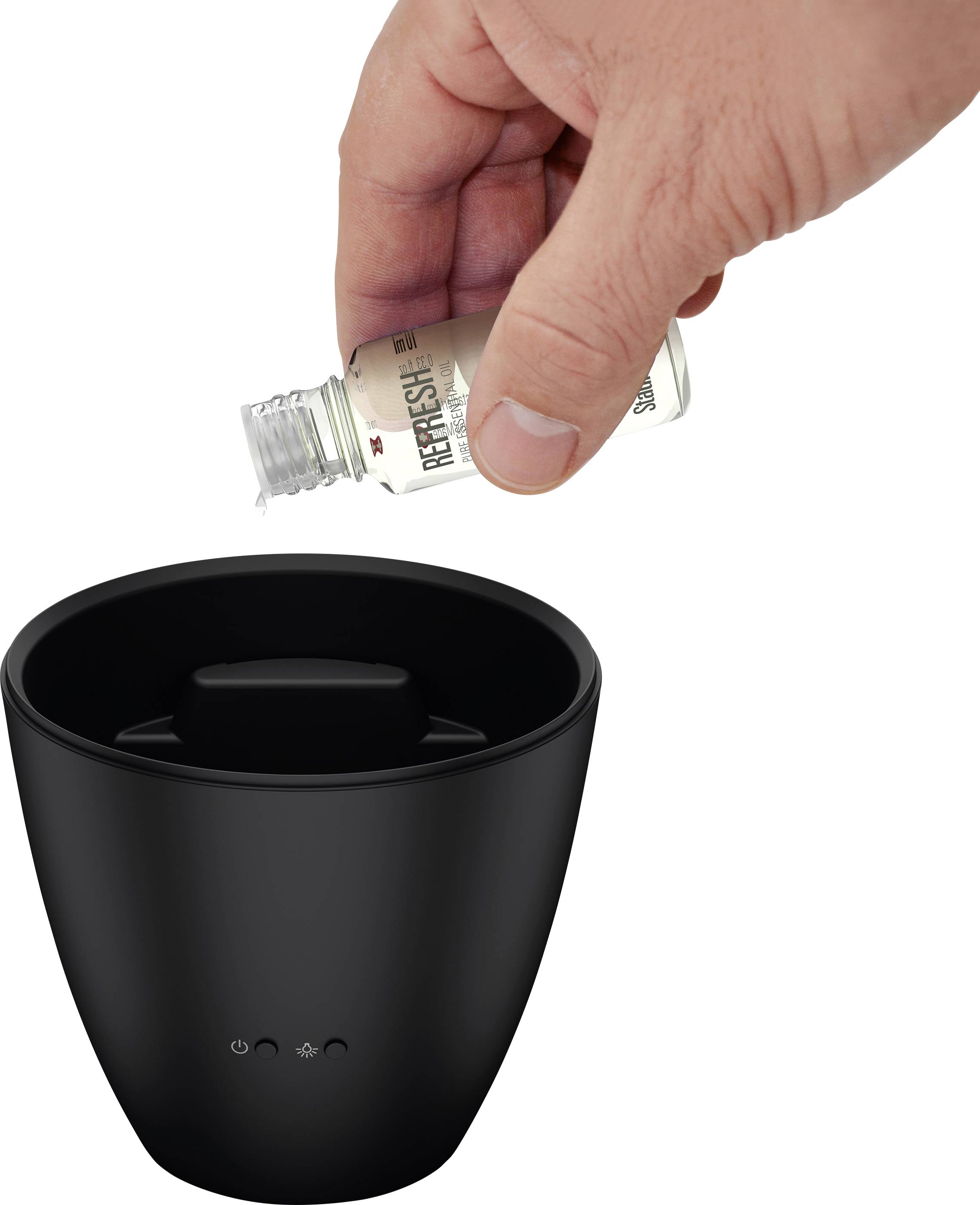 A hand is holding a 'Refresh' bottle and pouring liquid into a black aroma diffuser.
