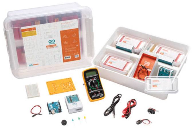 Arduino Starter Kit with various electronic components: Arduino board, multimeter, breadboard, cables and additional tools.
