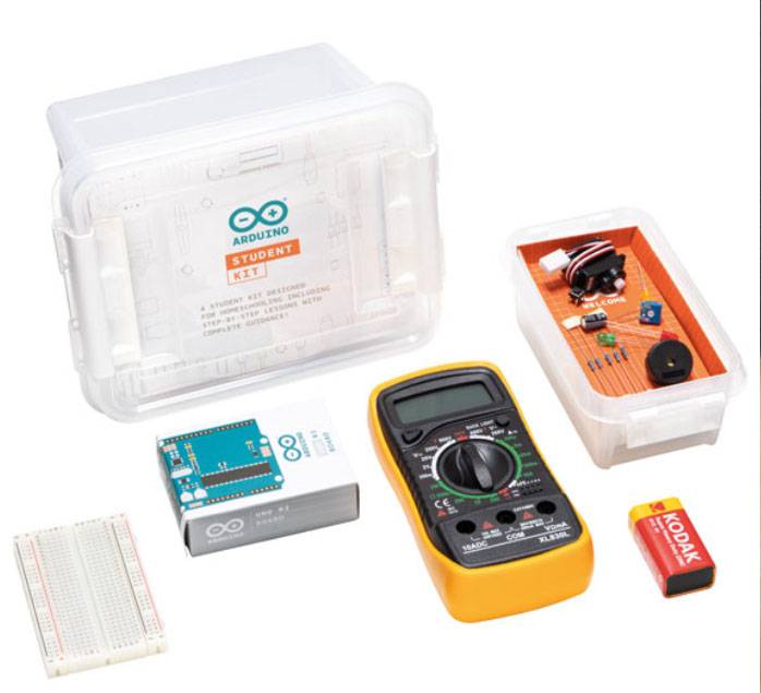An electronics kit with a multimeter, Arduino module, breadboard, 9V battery and various components in a clear storage box.