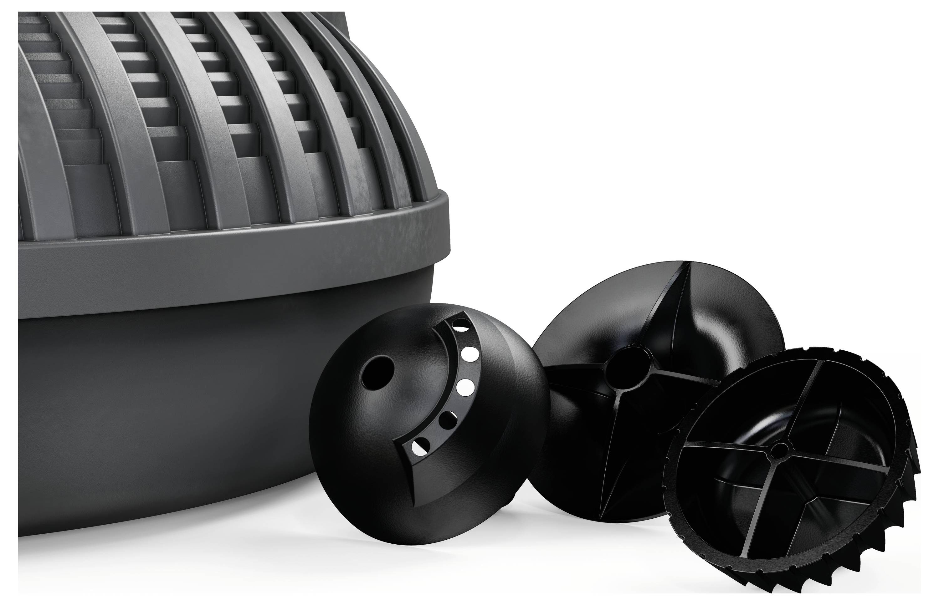 A group of black plastic washing balls with various textures and holes is placed next to a gray container lid.