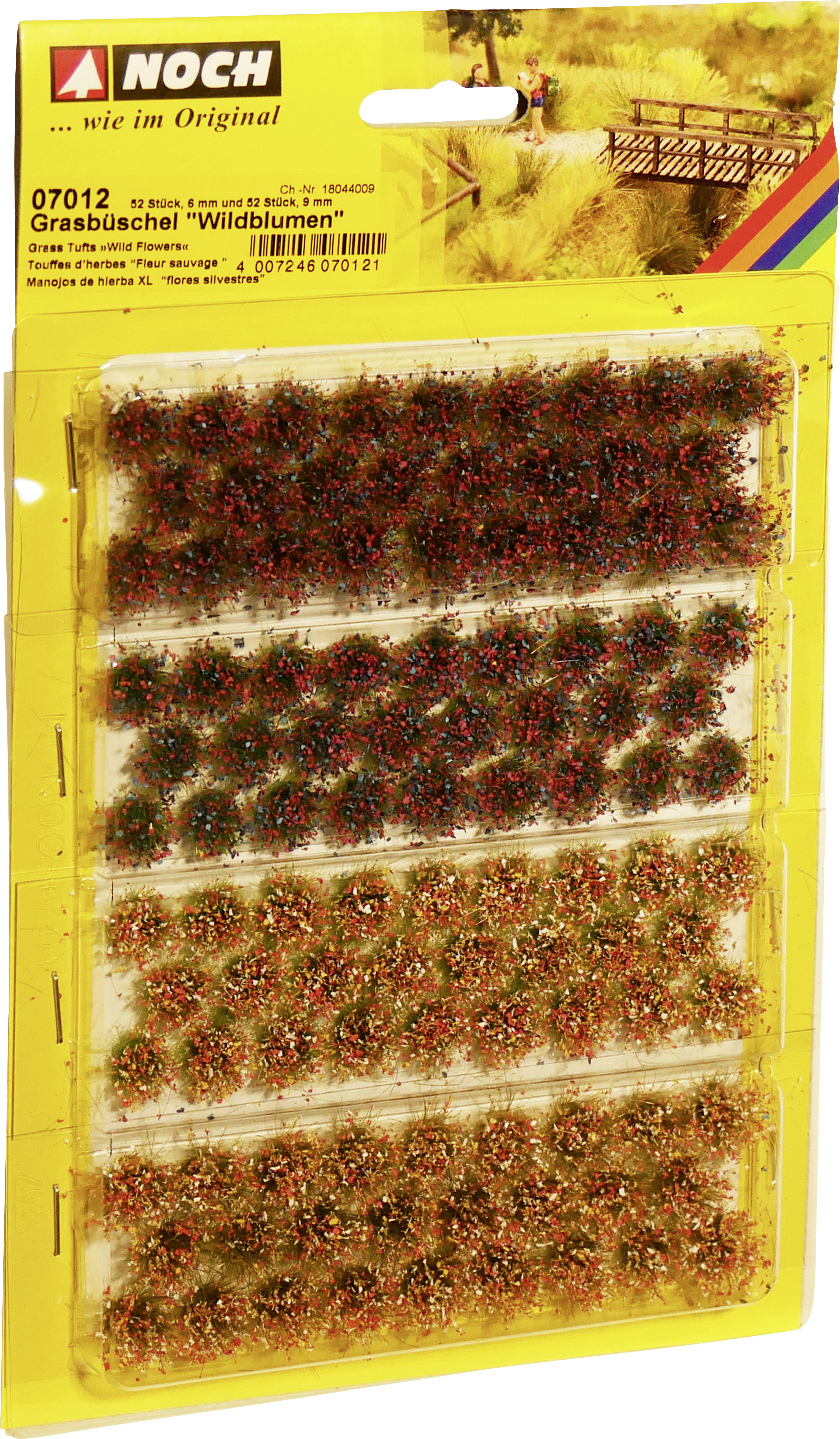 Packaging with 'Noch' brand model-building grass tufts, product 'Wild Flowers', item number 07012, on yellow cardboard.