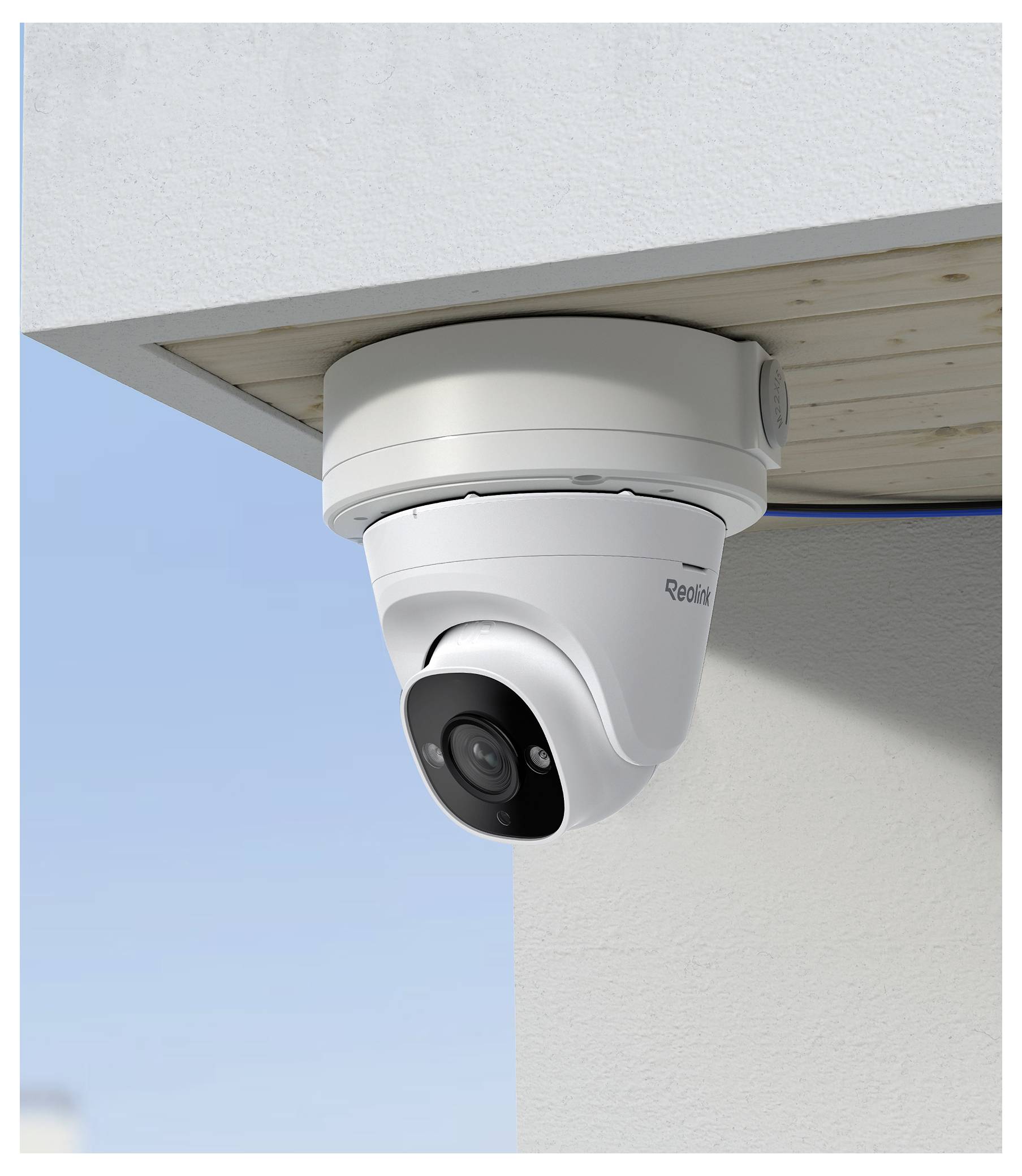 Security camera mounted on a building ceiling, facing downward.